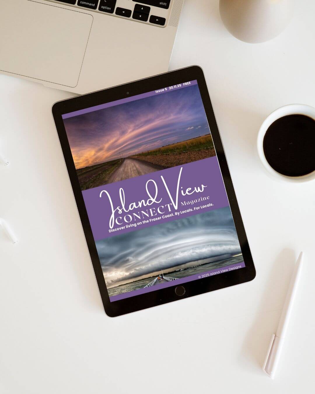 Tablet displaying 'Island View Connect' magazine cover with a laptop, coffee cup, and pen in the background.